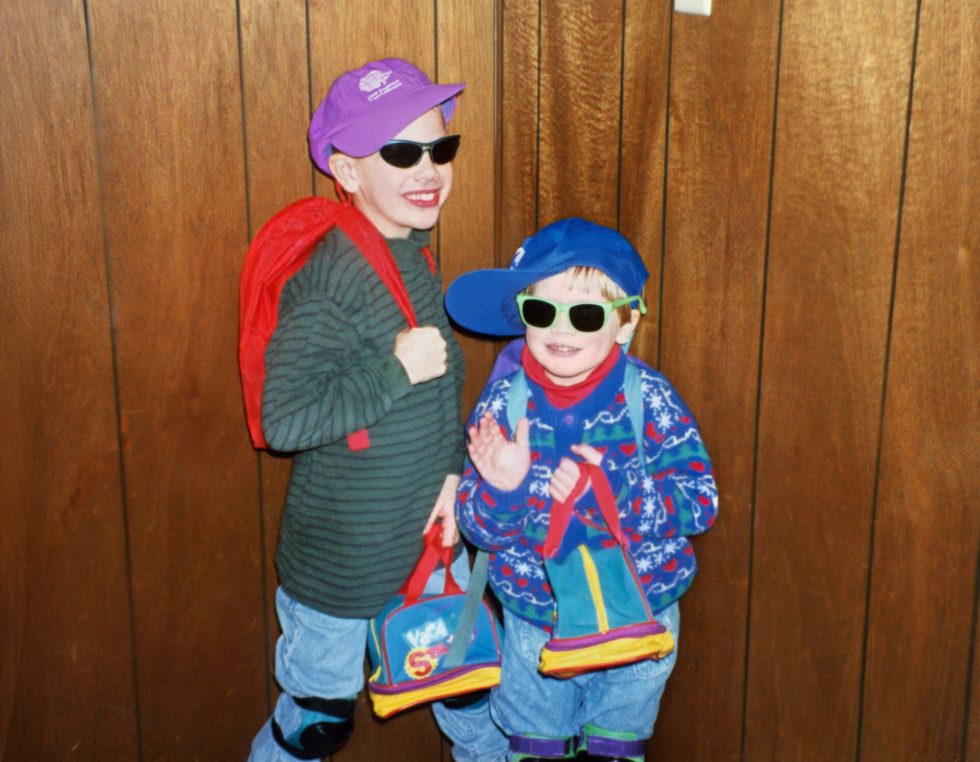 Two children wearing sunglasses and colorful outfits